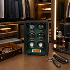 Close-up of a black and green leather watch winder in a luxury walk-in dressing room with elegant watches and mirrors.
