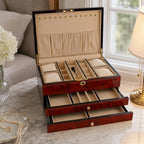 Jewellery box in a bedroom setting on marble tabletop, open to show spacious interior and plush camel lining.