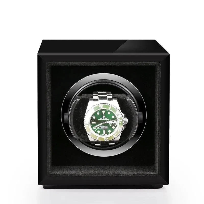 Aevitas single watch winder in high gloss piano black with a silver-accented interior holding a green Rolex watch.