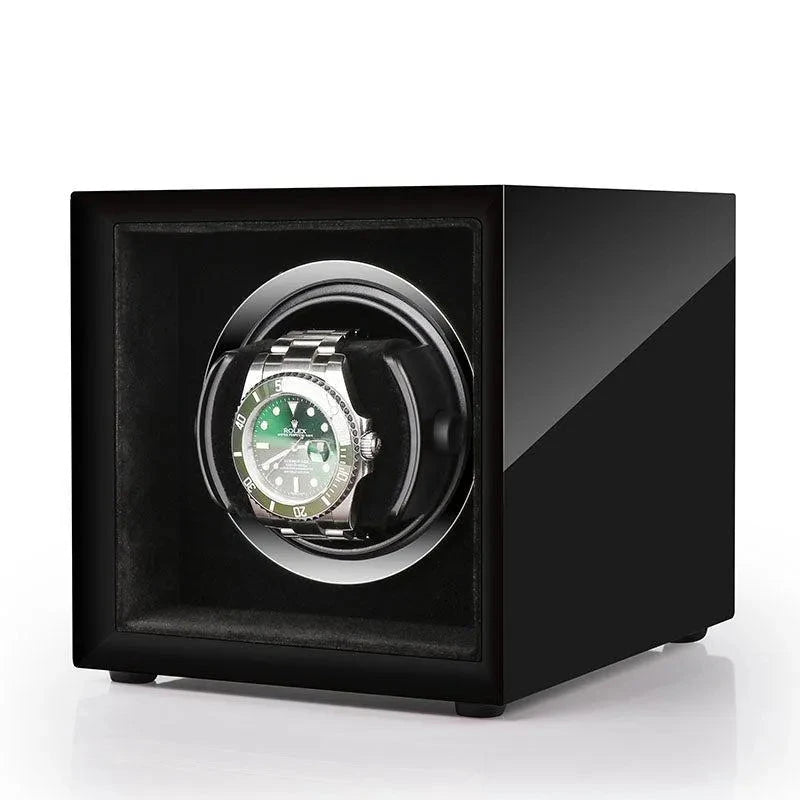 Aevitas high gloss piano black single watch winder with a silver-trimmed interior holding a green automatic watch.