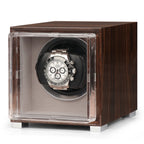 Single watch winder in glossy ebony Macassar wood with a clear glass door and a silver chronograph watch inside.