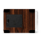 Bottom view of an ebony macassar wood watch winder featuring a black battery compartment and four protective rubber feet.