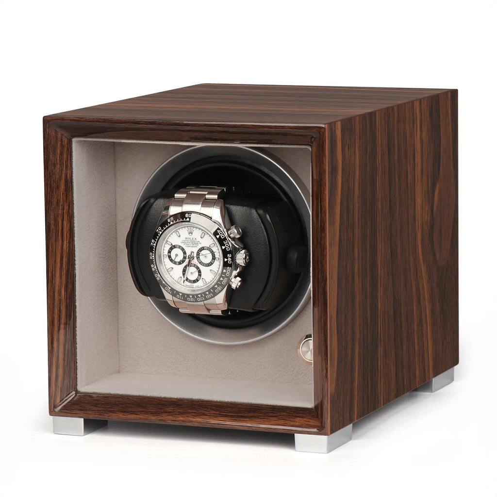 Single watch winder in glossy Ebony Macassar wood with a soft grey interior, featuring a silver automatic watch inside.