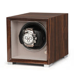 Single watch winder in glossy Ebony Macassar wood with a soft grey interior, featuring a silver automatic watch inside.