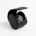 Black genuine leather watch travel case by Aevitas with soft lining, protecting watches during travel, shown with a shadow highlighting texture and quality.