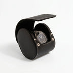 Black genuine leather watch travel case by Aevitas with soft lining, protecting watches during travel, shown with a shadow highlighting texture and quality.