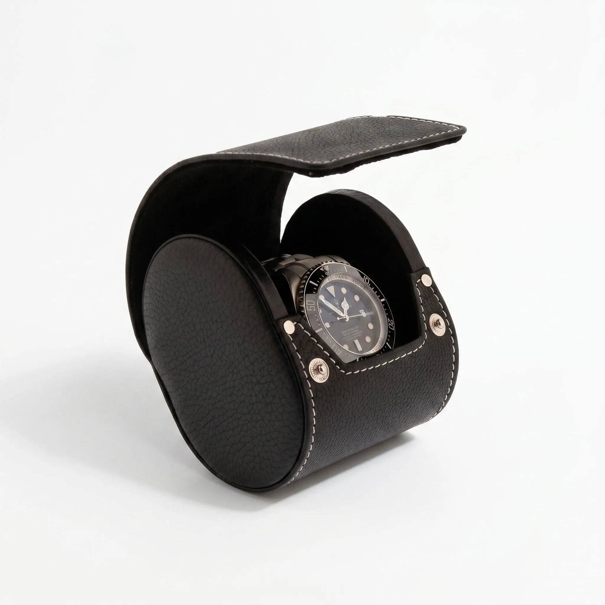 Black genuine leather watch travel case by Aevitas with soft lining, protecting watches during travel, shown with a shadow highlighting texture and quality.
