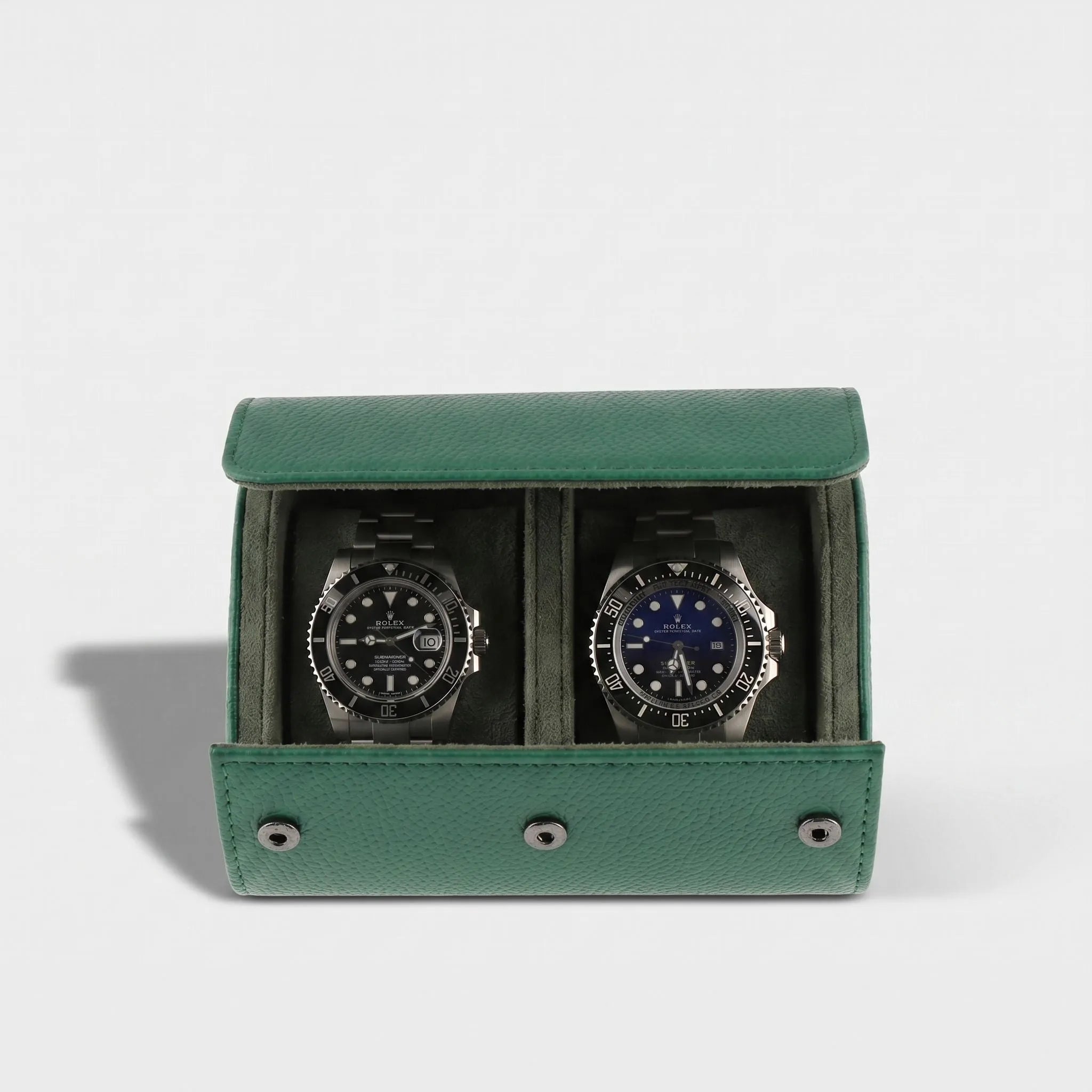 Close-up of a premium green leather watch roll with soft suede lining, gentle right-side shadow, and seamless background highlighting craftsmanship.