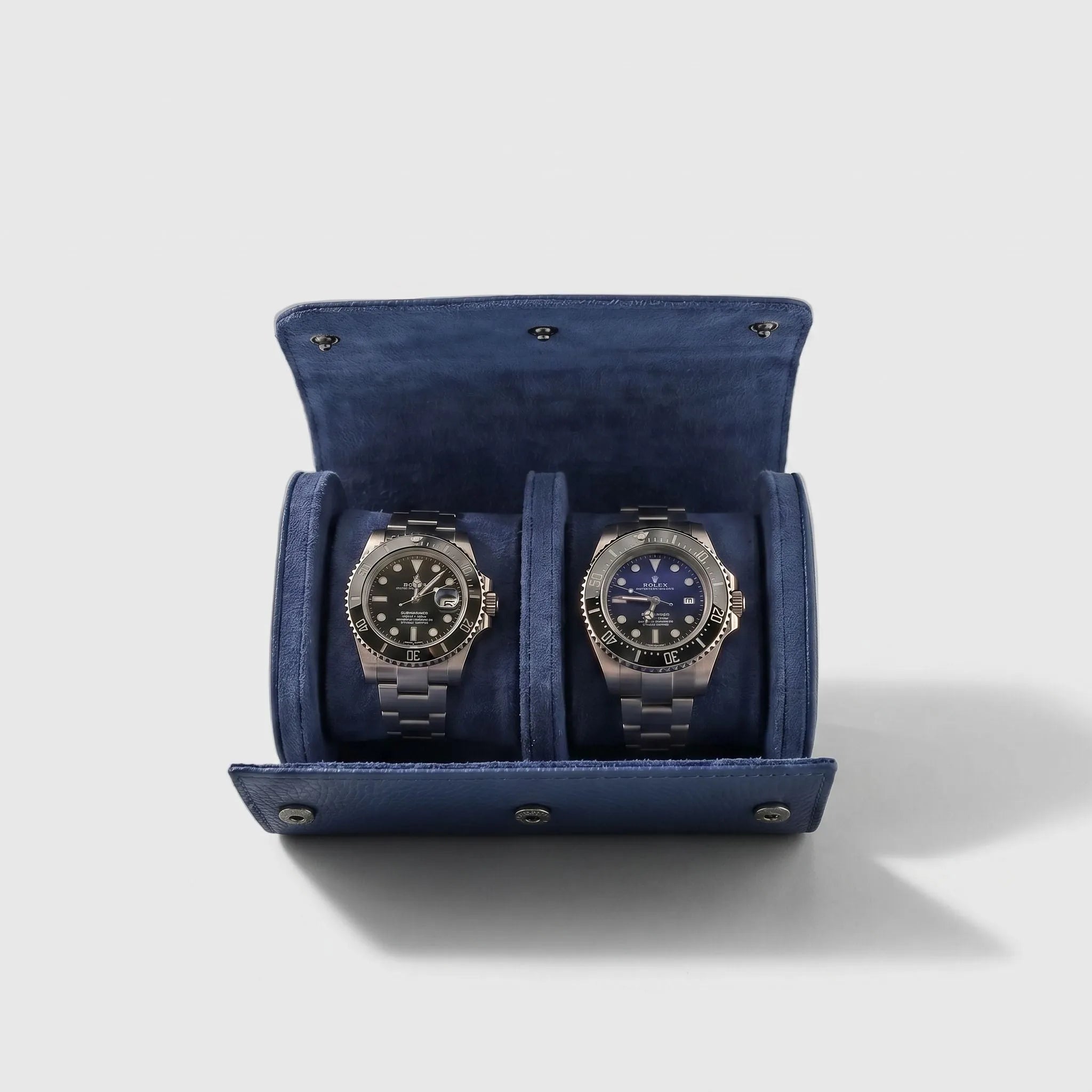 Blue leather double watch roll with soft suede lining, ideal for travel and watch storage, featuring compact design and secure fit.