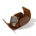 Close-up of a premium brown vegan leather watch roll with soft suede lining, showing craftsmanship and texture detail.