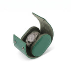 Green vegan leather watch roll with soft suede lining, compact and stylish, ideal for travel storage of one watch with gentle right-side shadow.