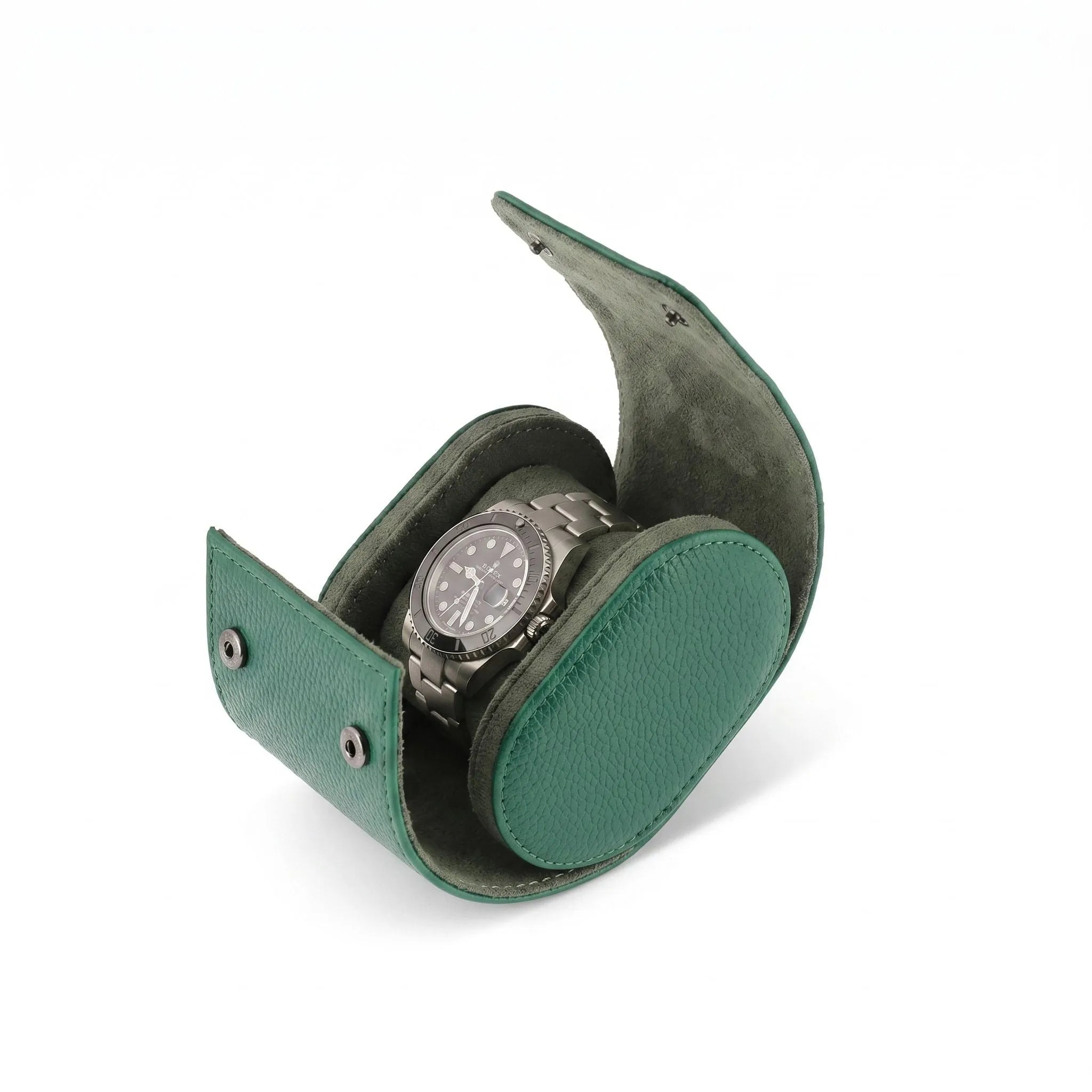 Green vegan leather watch roll with soft suede lining, compact and stylish, ideal for travel storage of one watch with gentle right-side shadow.
