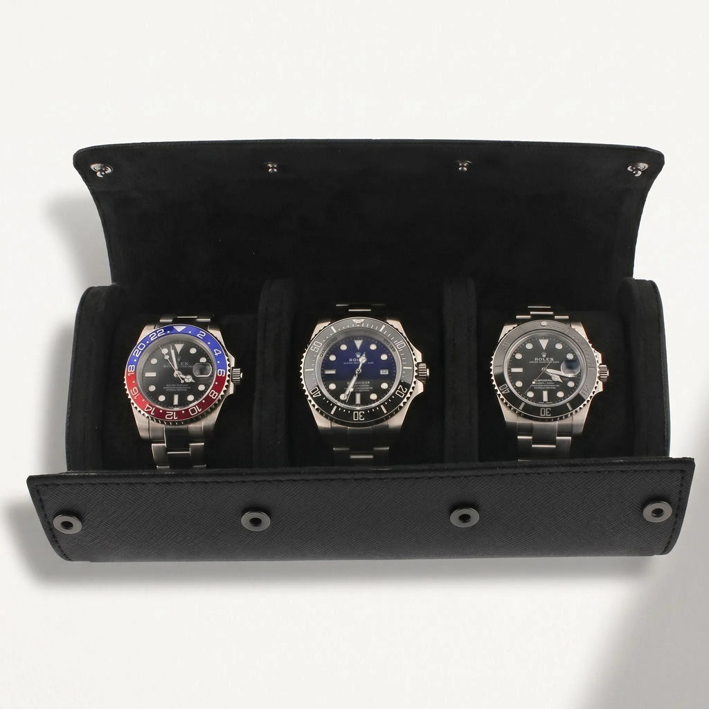 Elegant black vegan leather watch roll with suede lining, designed for safe storage of multiple watches during travel, with a shadow from natural lighting.