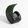 Single watch roll case in black Nappa leather with green Alcantara lining, showcased on a white surface with a gentle light and shadow effect.