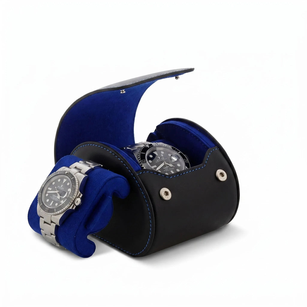 High-quality image of a single watch roll case in black Nappa leather with blue lining, placed on a white marble surface, highlighting craftsmanship and details.