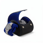 High-quality image of a single watch roll case in black Nappa leather with blue lining, placed on a white marble surface, highlighting craftsmanship and details.