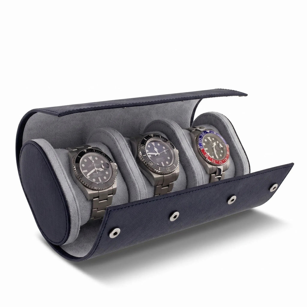 Close-up of navy blue saffiano leather triple watch roll with soft lining, focus on texture and shadow, product on plain white background.