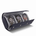 Close-up of navy blue saffiano leather triple watch roll with soft lining, focus on texture and shadow, product on plain white background.