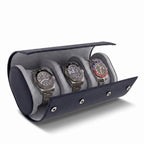 Close-up of navy blue saffiano leather triple watch roll with soft lining, focus on texture and shadow, product on plain white background.