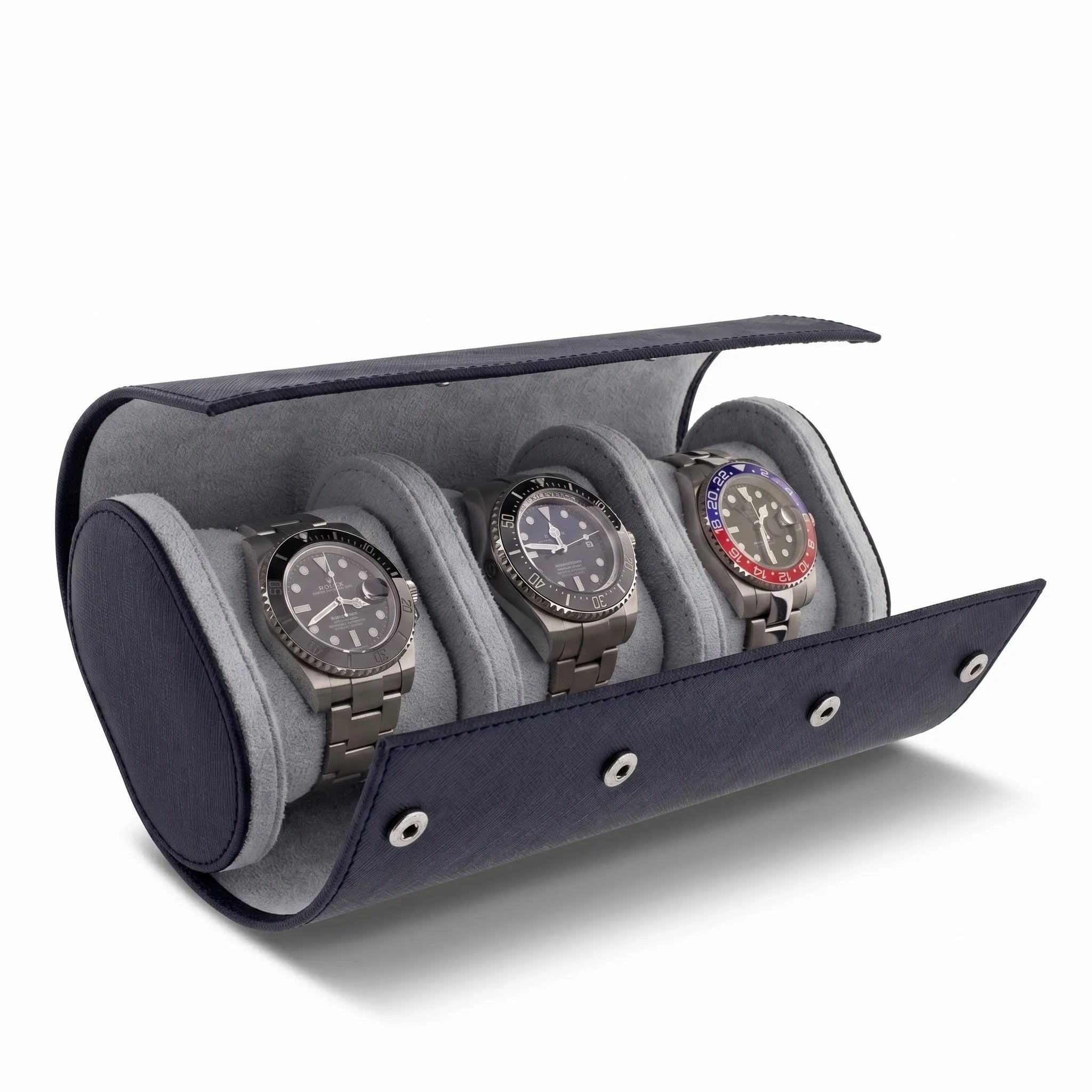 Close-up of navy blue saffiano leather triple watch roll with soft lining, focus on texture and shadow, product on plain white background.